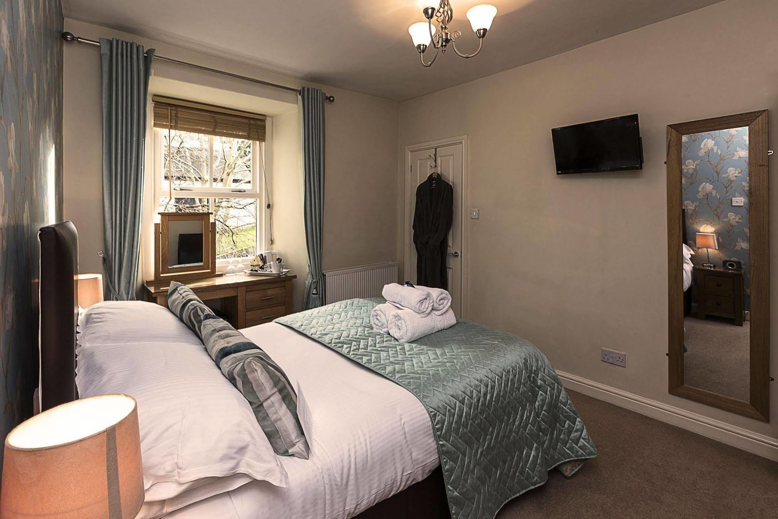 Example guest room with blue floral wallpaper