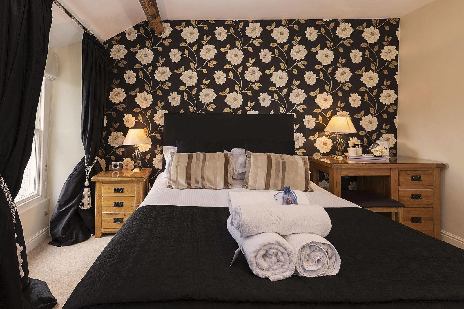 Example boutique guest room with black floral wallpaper