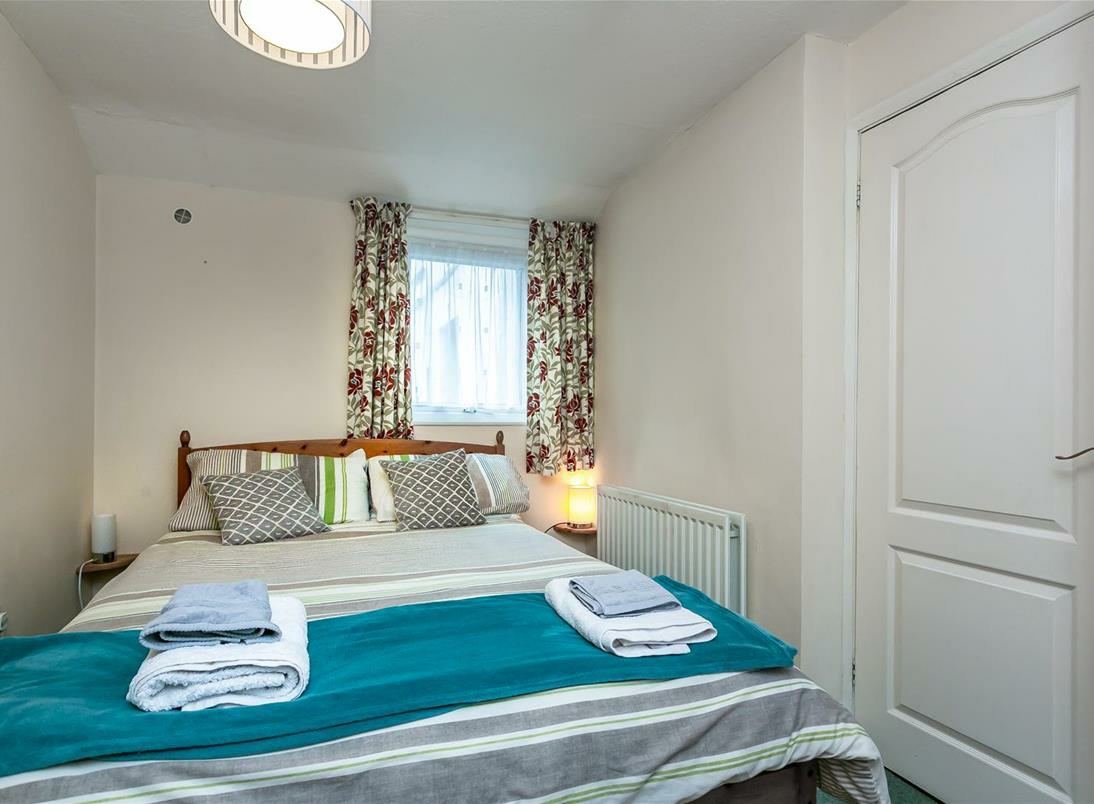 Example guest room with teal bed throw